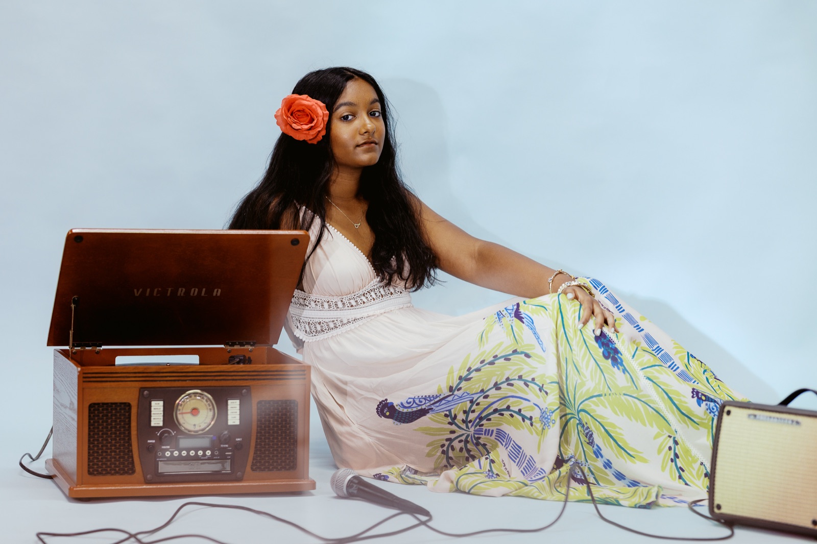 Anya beside the record player, looking to camera